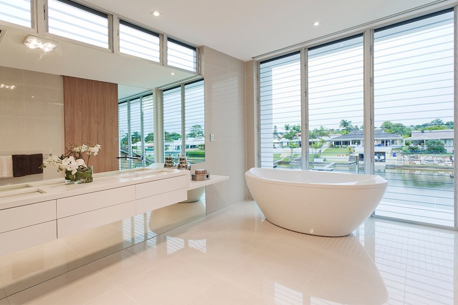 New bathroom with white tiled floor, white bath and white cabinets | Featured Image for the Bathroom Cabinets Brisbane page of Kitchen U.