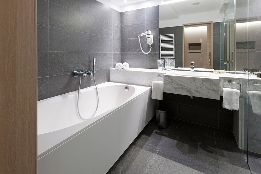 Modern bathroom with white marble sink and grey tiles | Featured Image for the Bathroom Cabinets Brisbane page of Kitchen U.