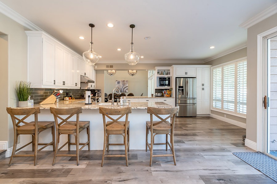 Image of a new kitchen with wooden chairs, wood counter tops and plenty of natural light | Featured Image for Flat Pack Kitchens Brisbane.